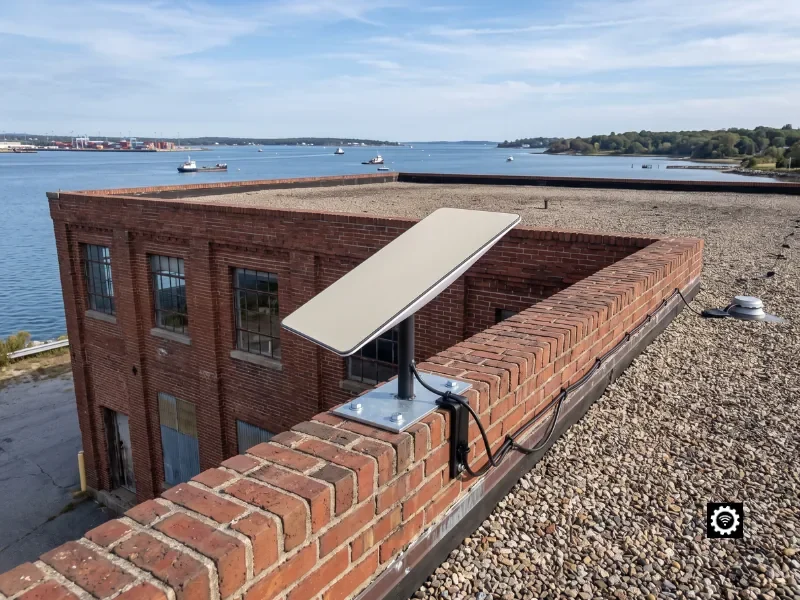 Commercial Starlink dish parapet-mounted on an authentic Rhode Island commercial building