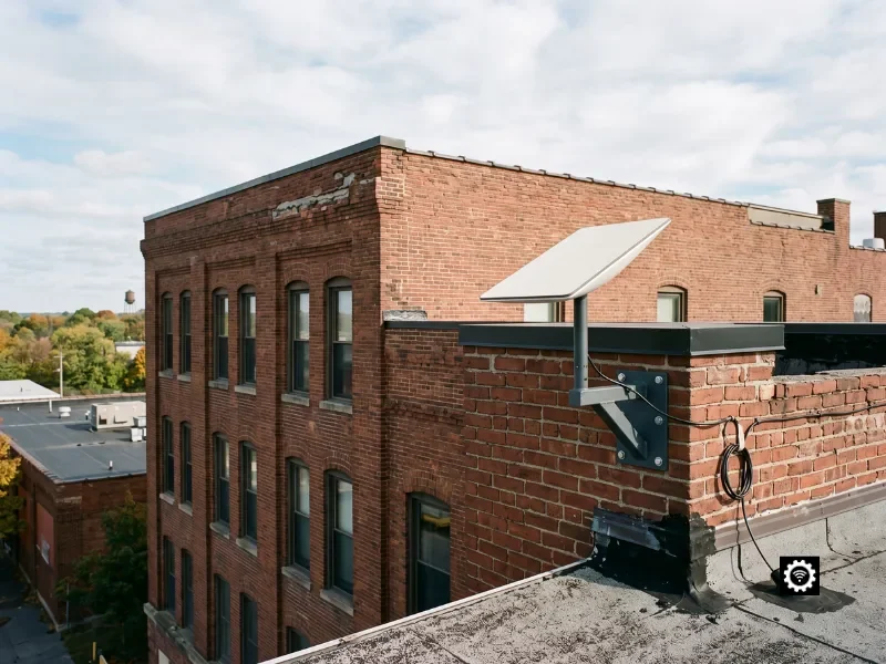 Commercial Starlink dish parapet-mounted on an authentic New York commercial building